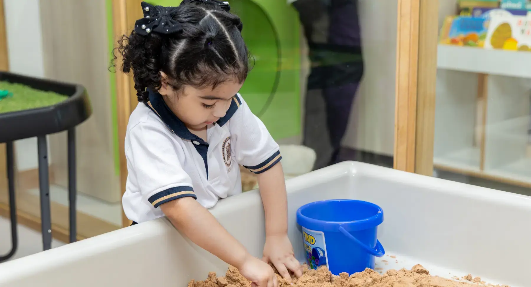 Sherborne School Jeddah student playing at a sandbox.