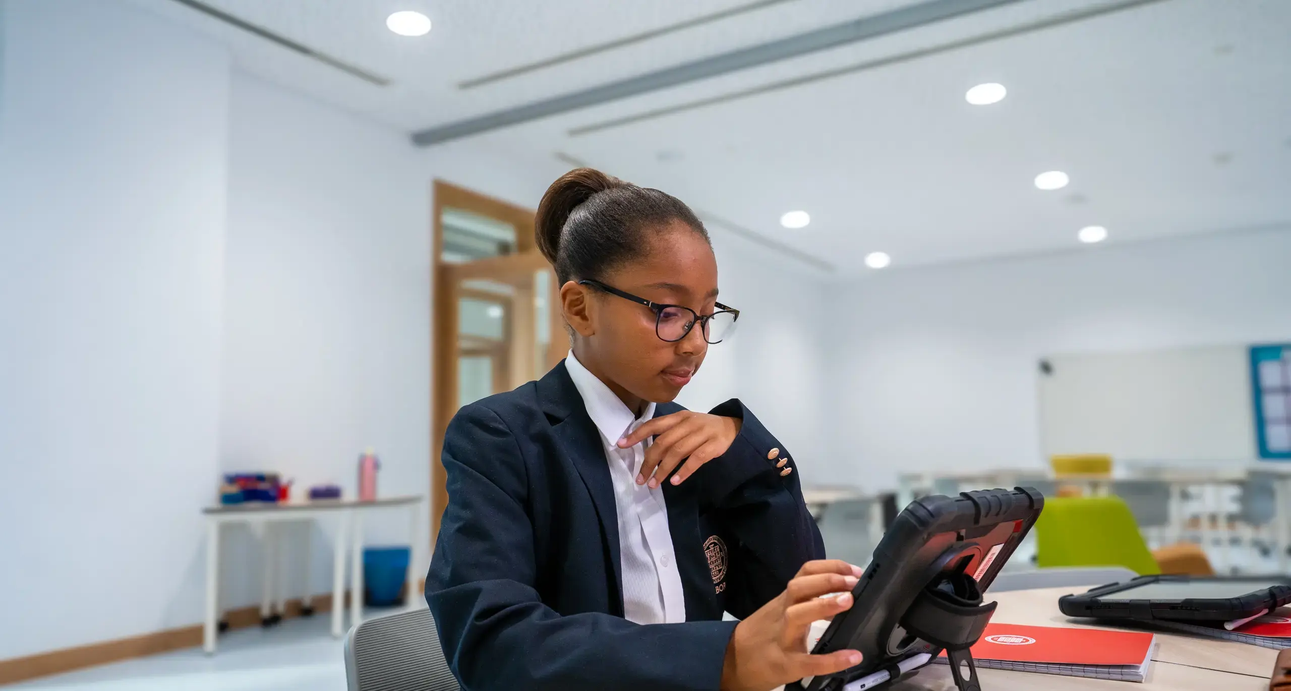 Sherborne School Jeddah student completing classwork on a tablet.