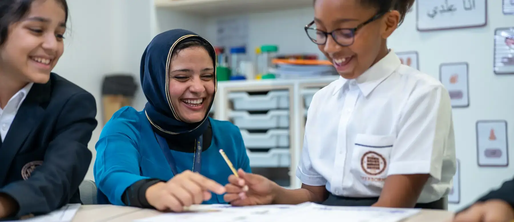 Sherborne School Jeddah teacher helping students with classwork.