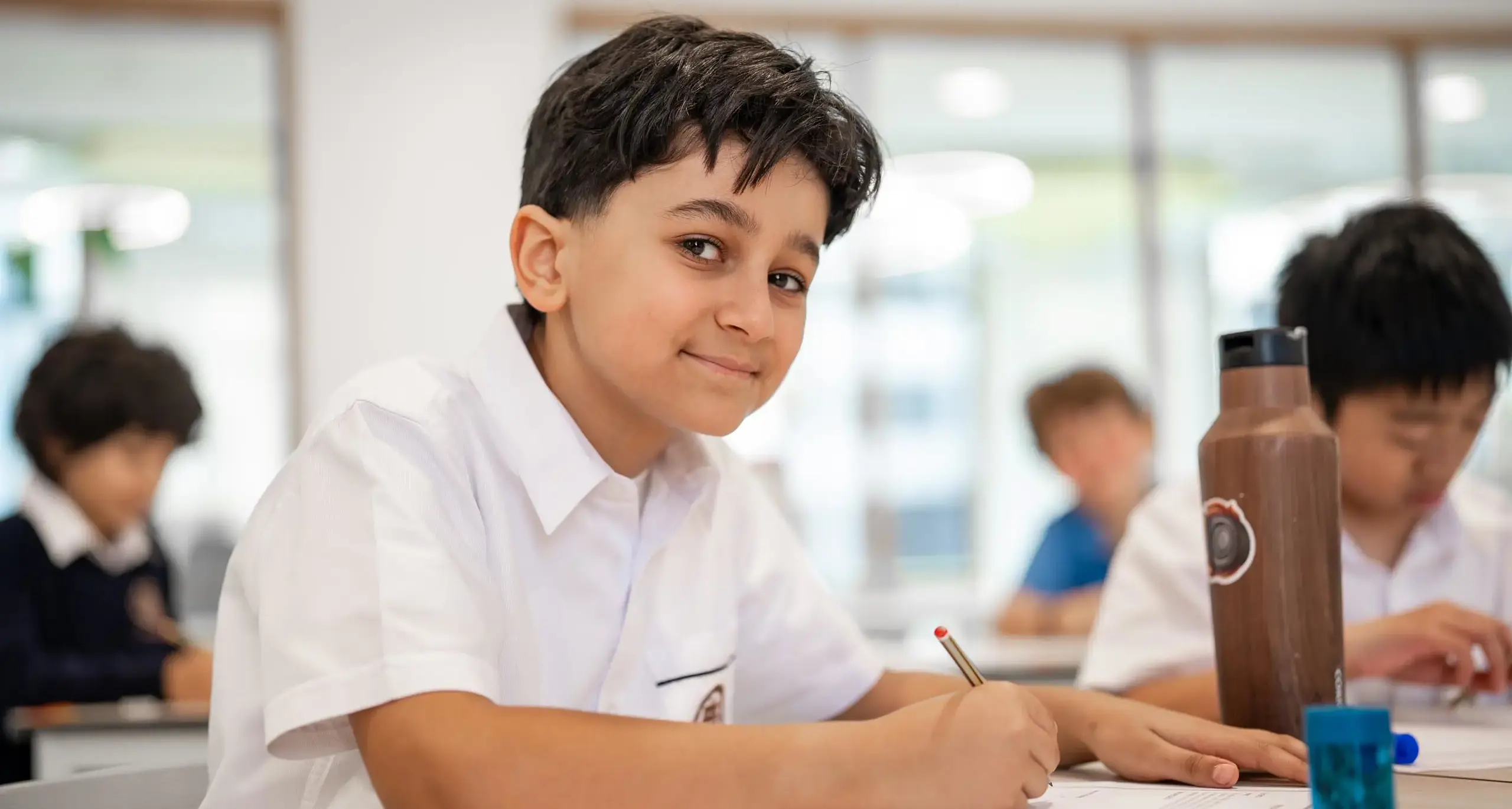 Sherborne School Jeddah student writing.