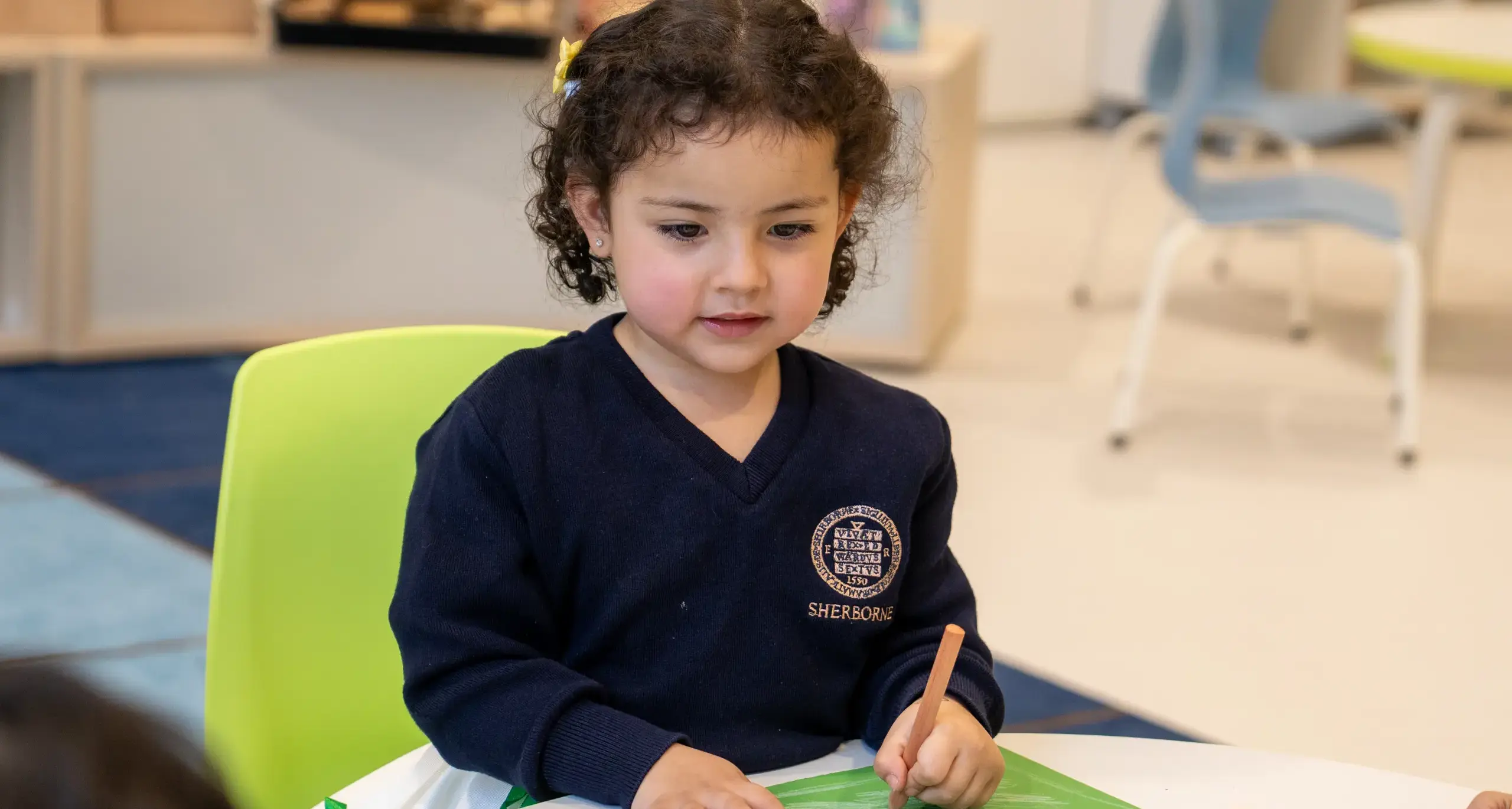 Sherborne School Jeddah student writing in a lesson.