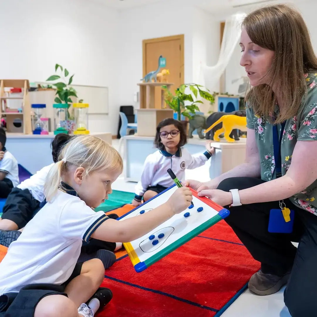 Sherborne School Jeddah teacher helping student in a lesson.