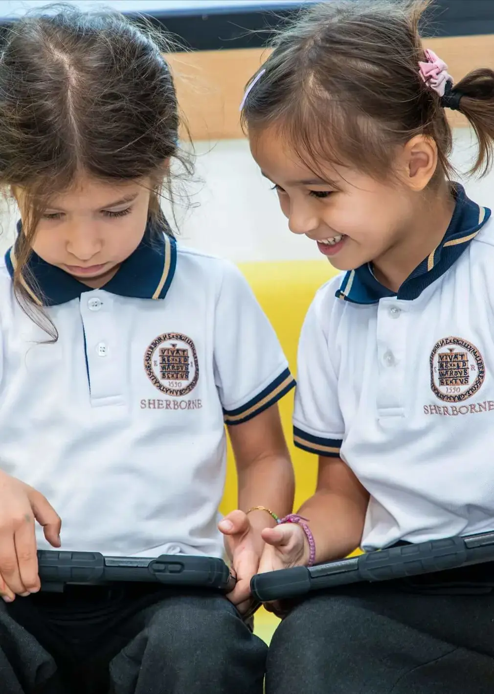 Sherborne School Jeddah students using tablets during a lesson.