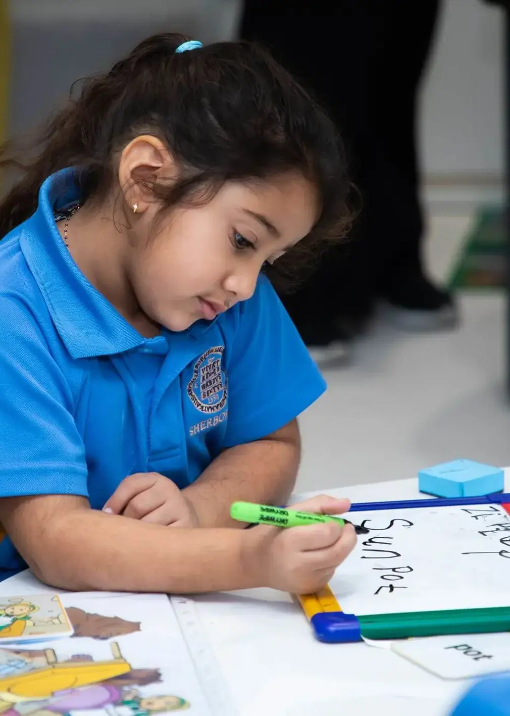 Sherborne School Jeddah pupil writing on a whiteboard in a lesson.