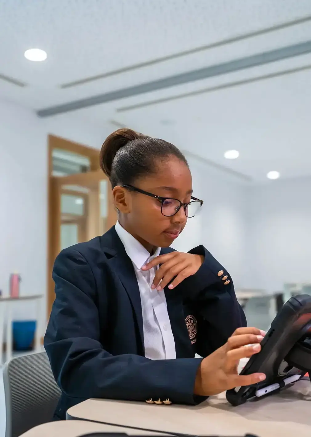 Sherborne School Jeddah student using a tablet in a lesson.