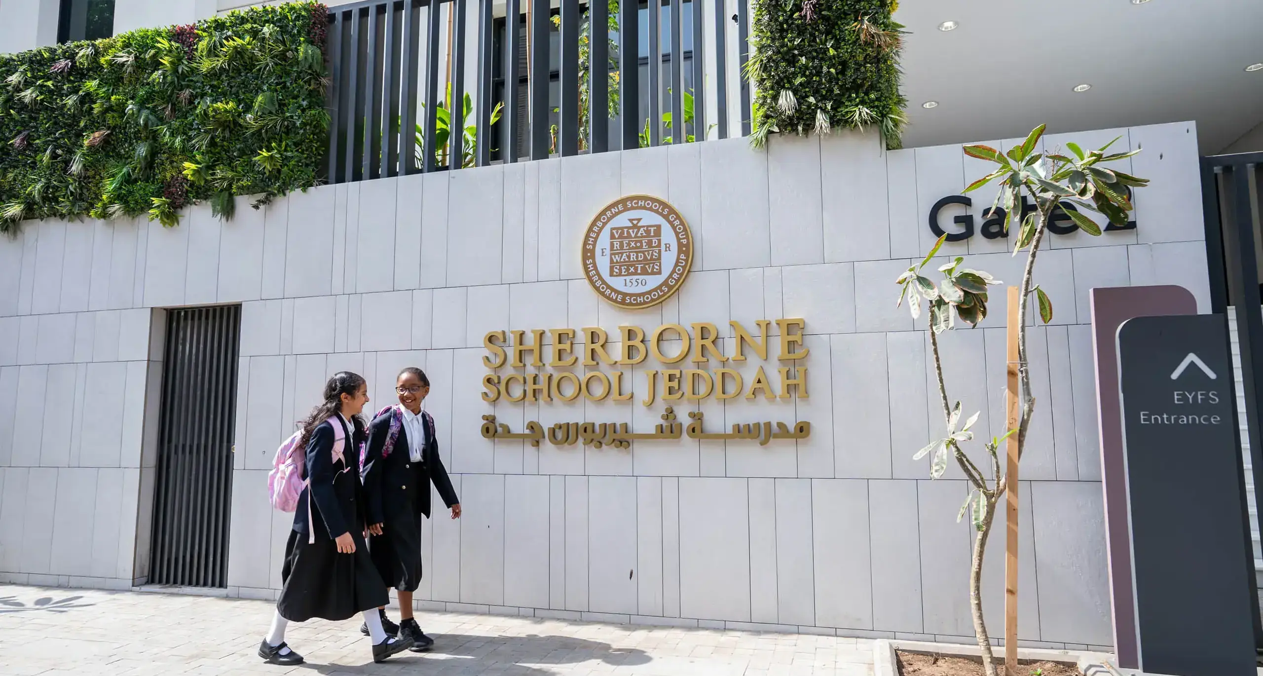 Sherborne School Jeddah students walking past main school building.