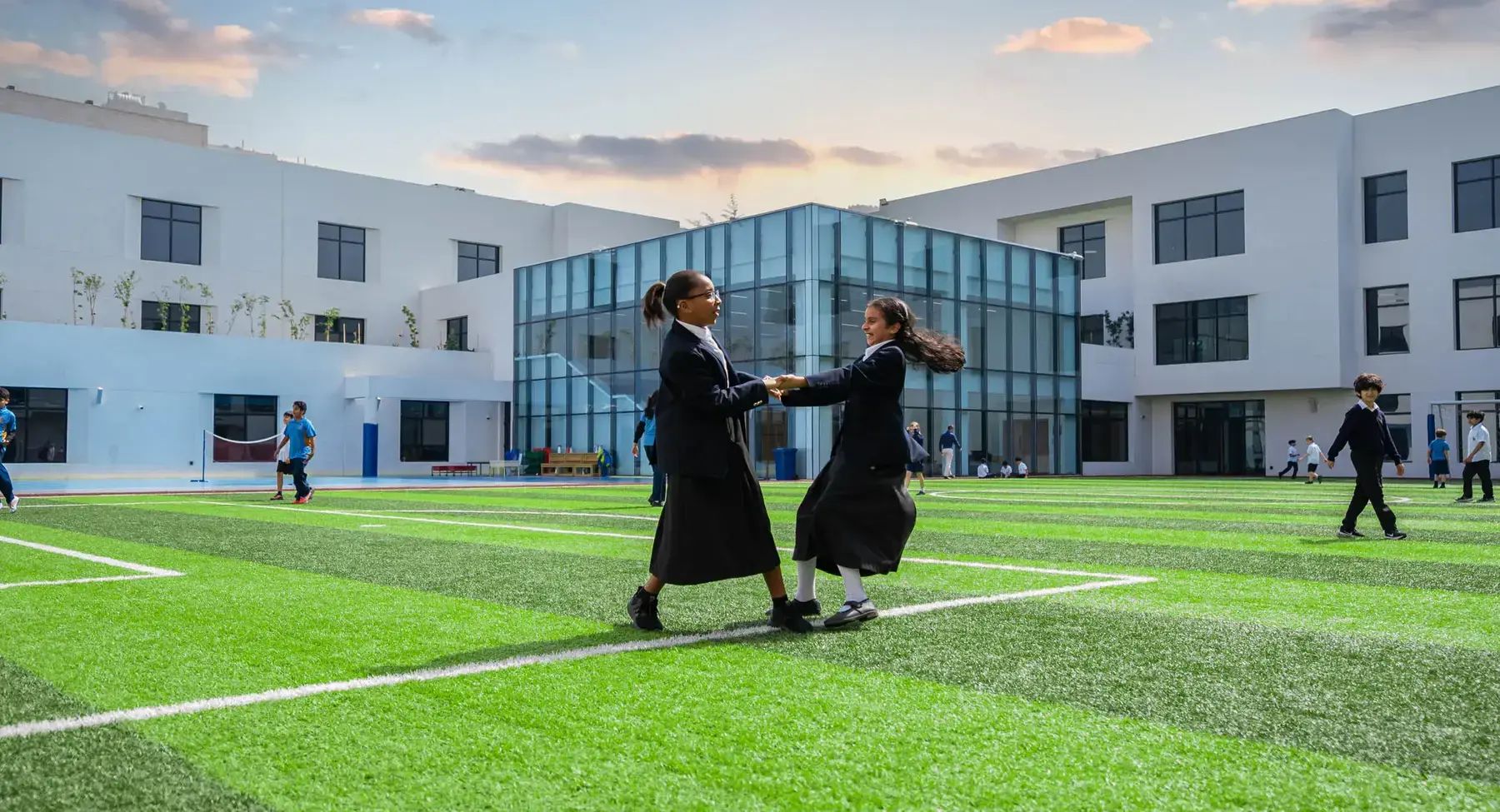 Sherborne School Jeddah students playing on a sports pitch.