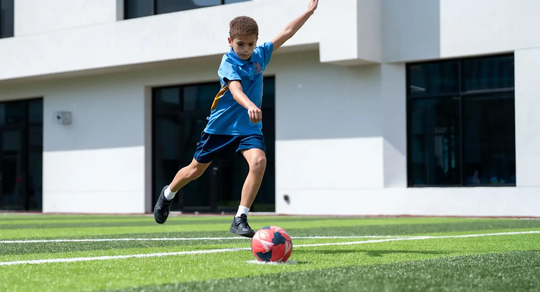Sherborne School Jeddah student playing football.